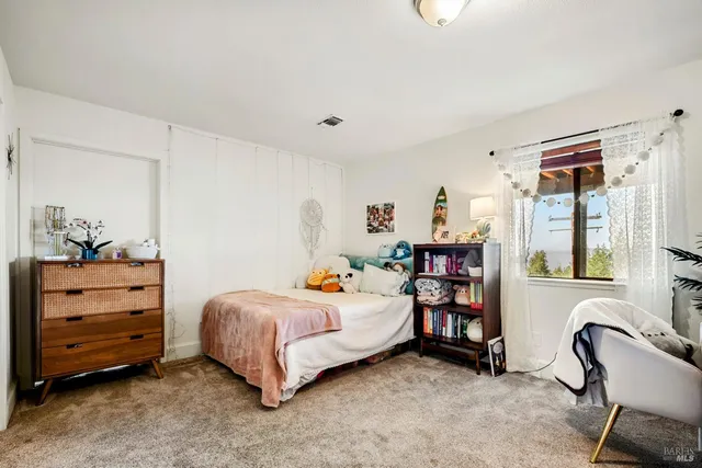 a view of a patio with table and chairs under an umbrella