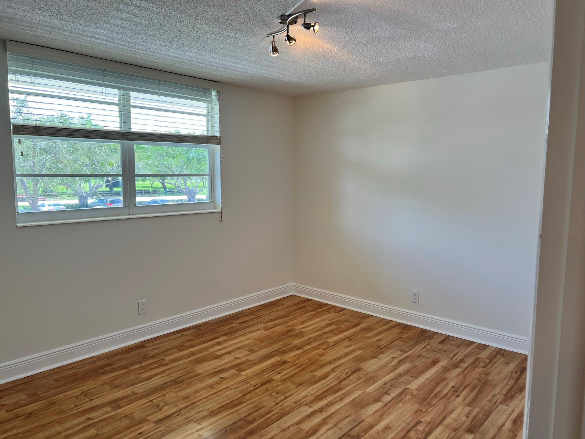 5700 Northwest 2nd Avenue, Unit 204 Boca Raton, FL 33487 - Photo 18 of 31 wooden floor in an empty room with a window