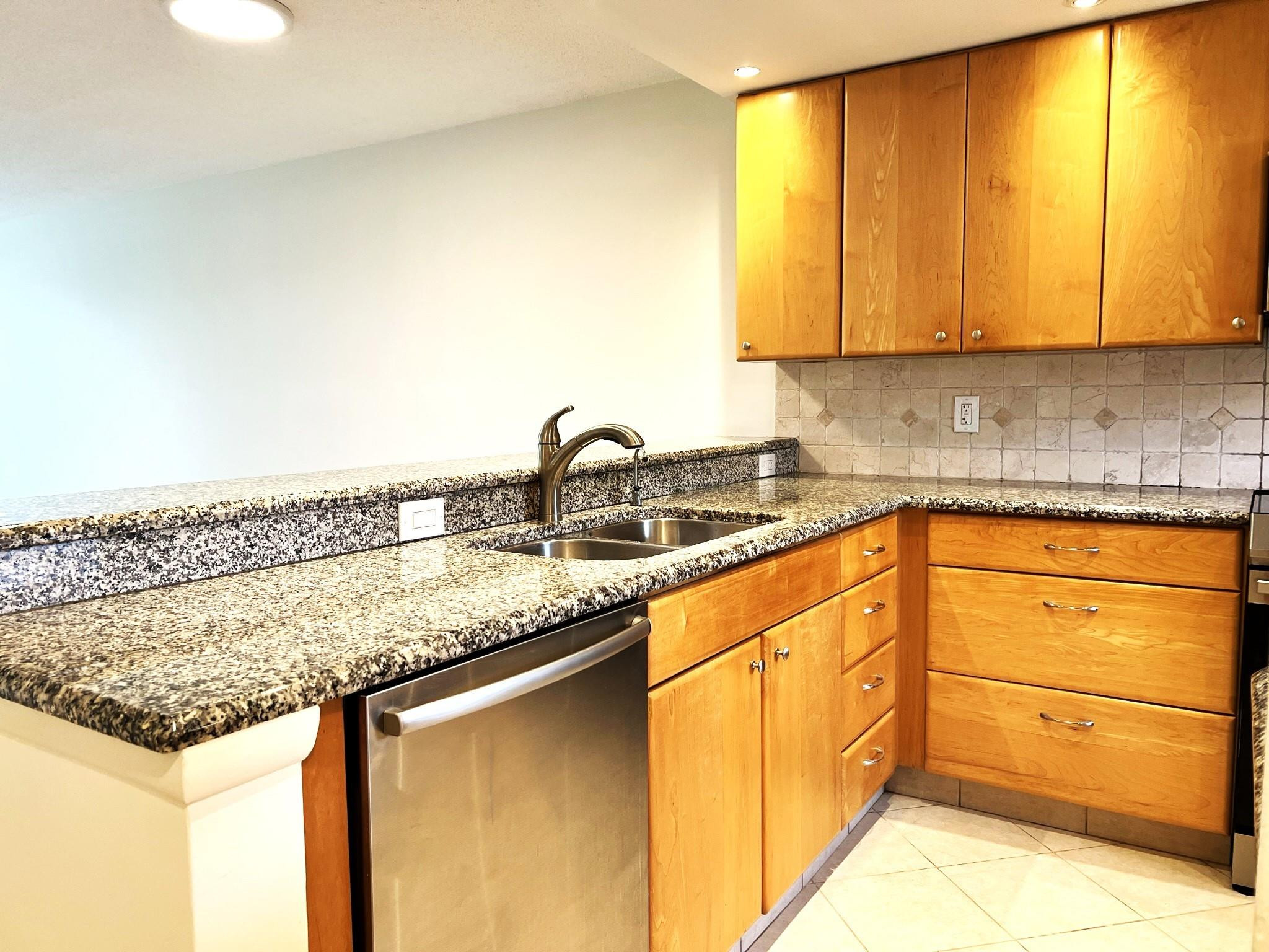 5700 Northwest 2nd Avenue, Unit 204 Boca Raton, FL 33487 - Photo 2 of 31 a kitchen with granite countertop cabinets and window