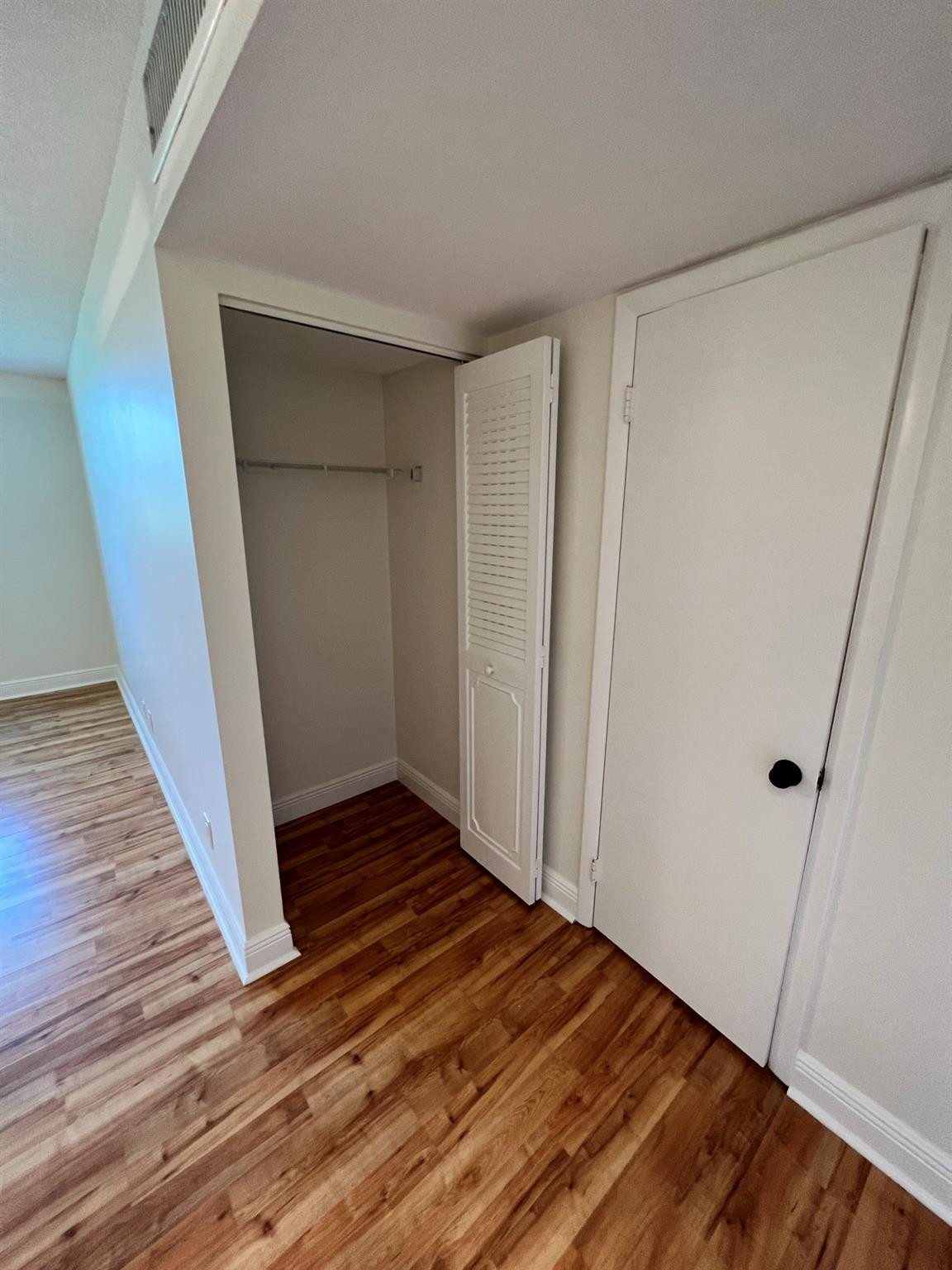 5700 Northwest 2nd Avenue, Unit 204 Boca Raton, FL 33487 - Photo 23 of 31 a view of an empty room with wooden floor and a window