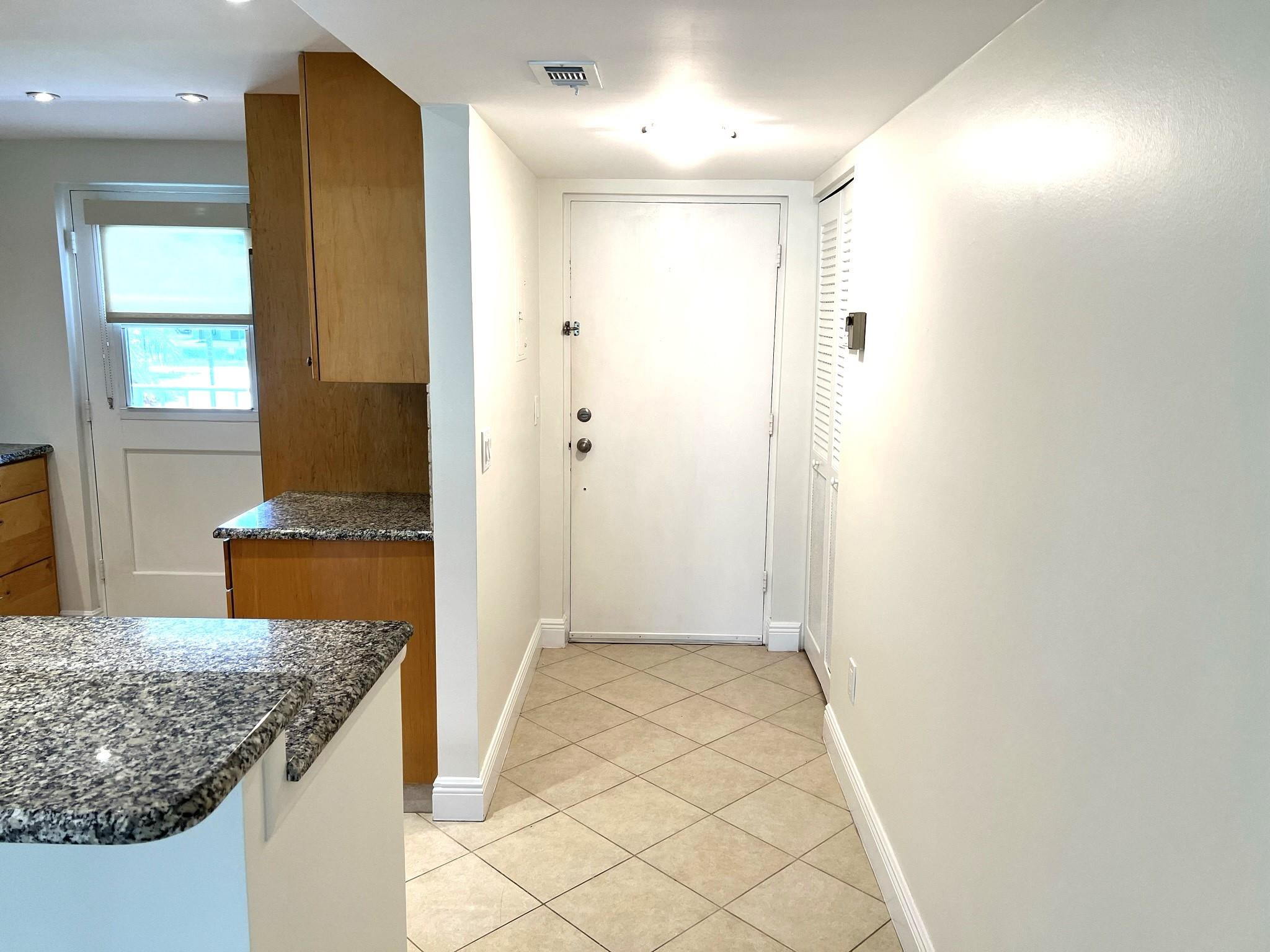 5700 Northwest 2nd Avenue, Unit 204 Boca Raton, FL 33487 - Photo 6 of 31 a bathroom with a granite countertop sink and a mirror