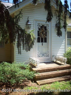 24 Heyers Mill Road Colts Neck, NJ 07722 - Photo 1 of 12 a front view of a house with a yard