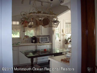 24 Heyers Mill Road Colts Neck, NJ 07722 - Photo 5 of 12 a bathroom with a sink a mirror and shower