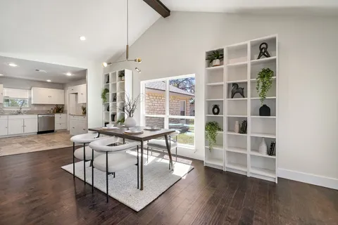 a kitchen with a refrigerator stove and white cabinets
