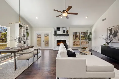 a living room with fireplace furniture and a wooden floor