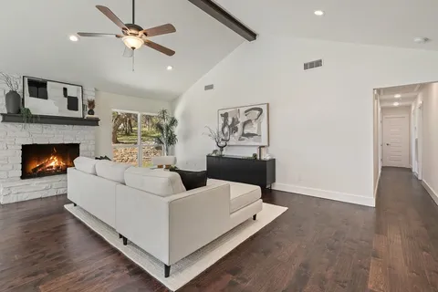 a view of a kitchen with furniture and wooden floor
