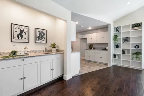 a kitchen with stainless steel appliances granite countertop a sink a stove a microwave and cabinets