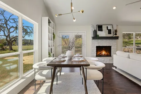 a kitchen with granite countertop a sink white cabinets and stainless steel appliances