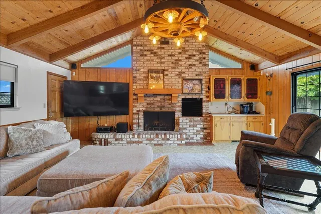 a living room with fireplace furniture and a flat screen tv