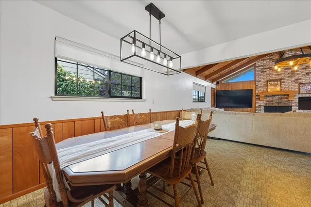 a view of a dining room with furniture and window