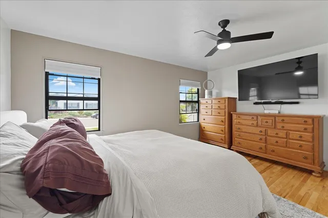 a bedroom with a bed and a flat screen tv
