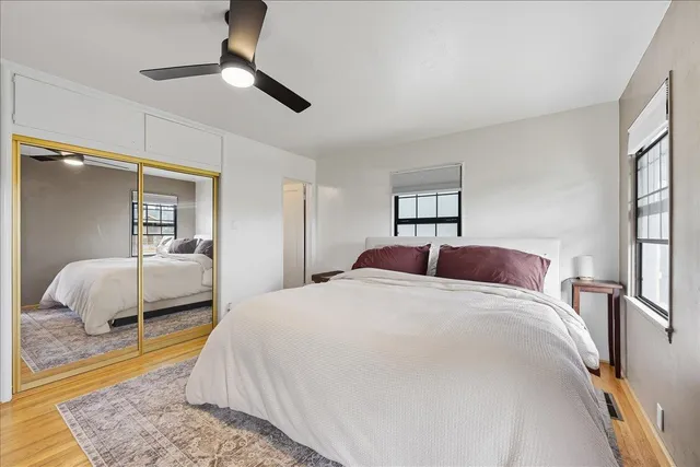 a bedroom with a bed and a mirror