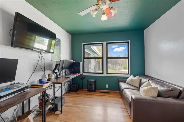 a living room with furniture and a flat screen tv