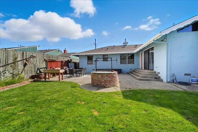 a view of a house with a yard and sitting area