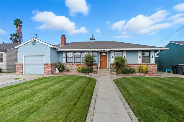 a front view of a house with a garden