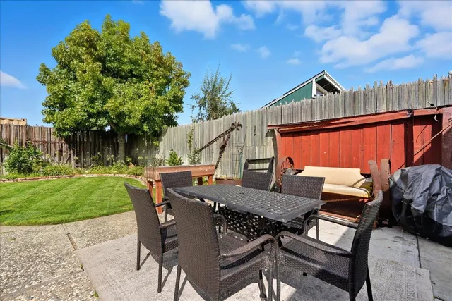 a view of backyard of house with seating space