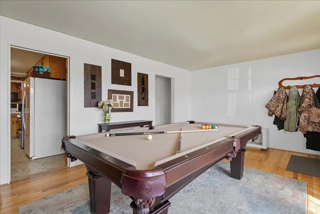 a room with pool table and windows