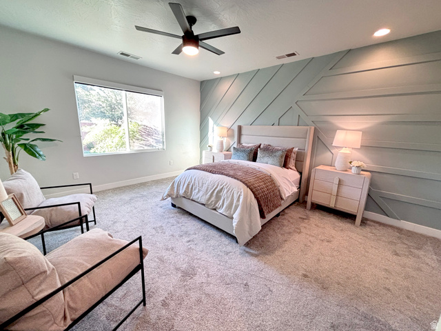 429 East Treasure Road Washington, UT 84780 - Photo 12 of 20 Accent wall with geometric paneling, recessed lighting, and a modern ceiling fan