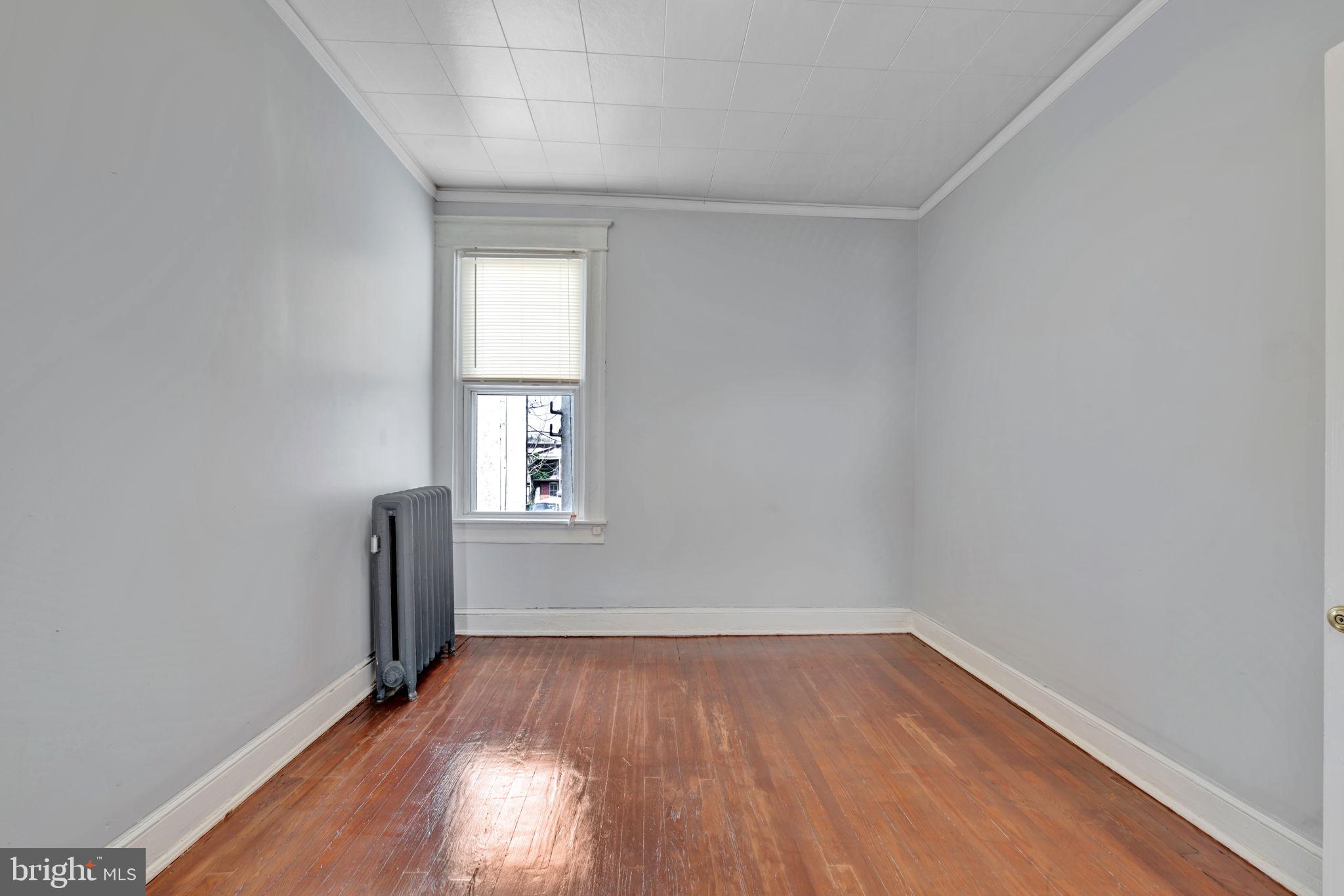 2822 Riggs Avenue Baltimore, MD 21216 - Photo 17 of 30 wooden floor in an empty room with a window