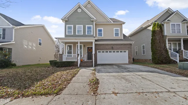 a front view of a house with a yard and garage