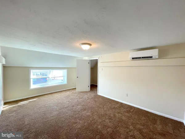 an empty room with a empty space and windows