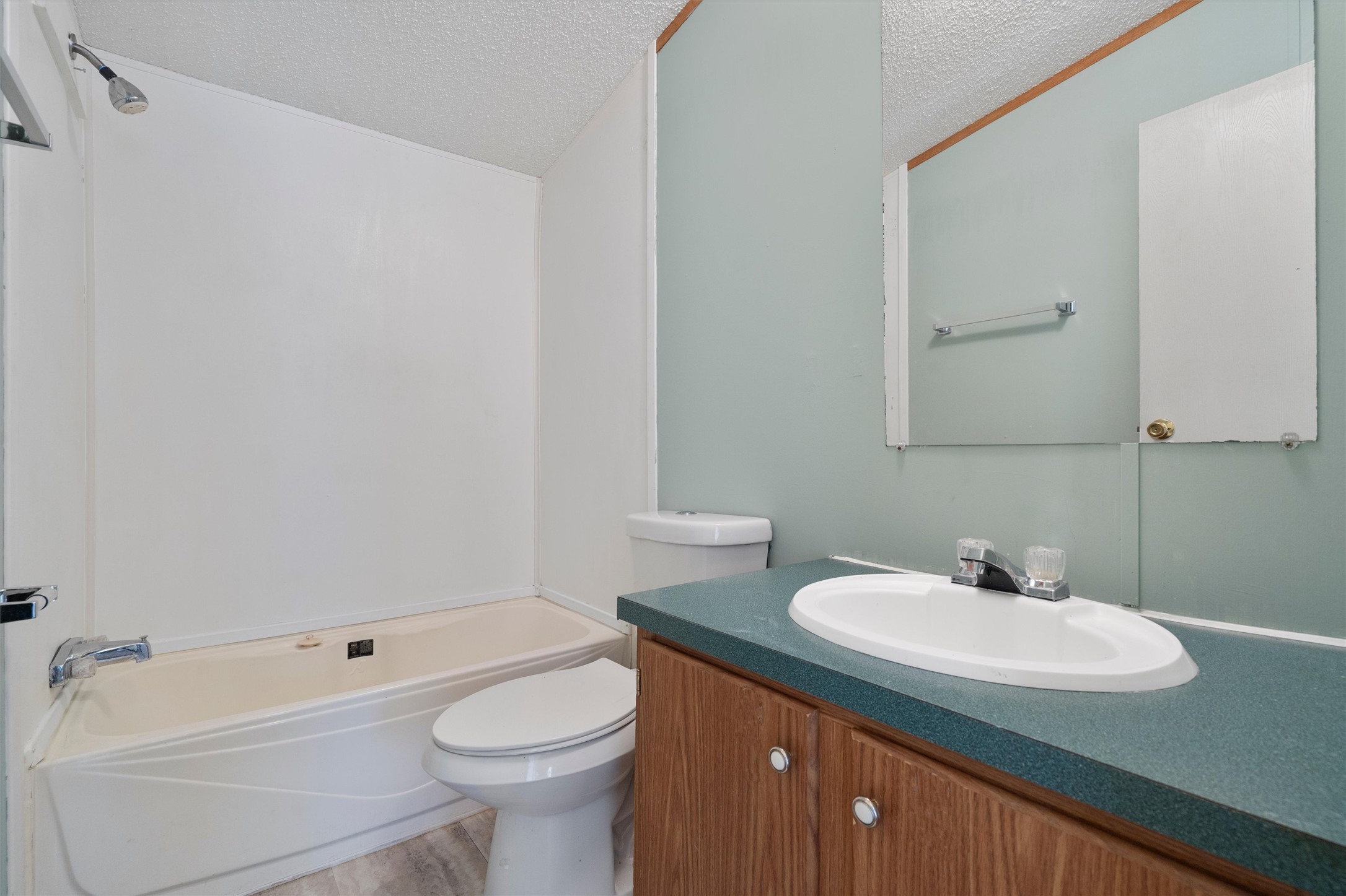 3075 Old Black Colony Road, Unit D Buda, TX 78610 - Photo 20 of 26 A functional bathroom setup includes a vanity with storage adjacent to a combined tub and shower.