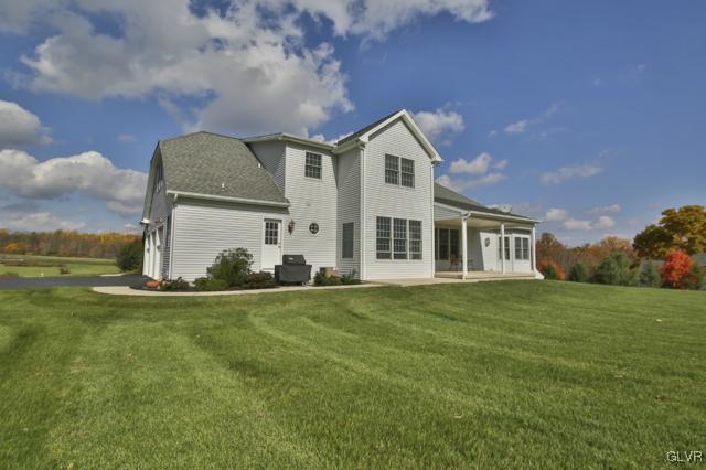 297 Meyer Road Nazareth, PA 18064 - Photo 4 of 41 a view of a house with a yard and garage