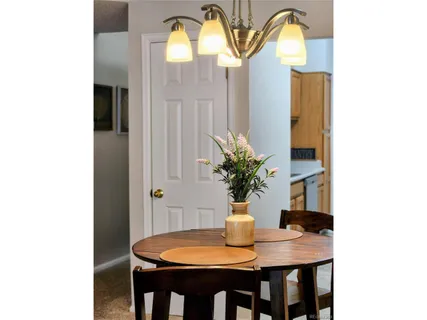 a view of a dining room with a table and chairs