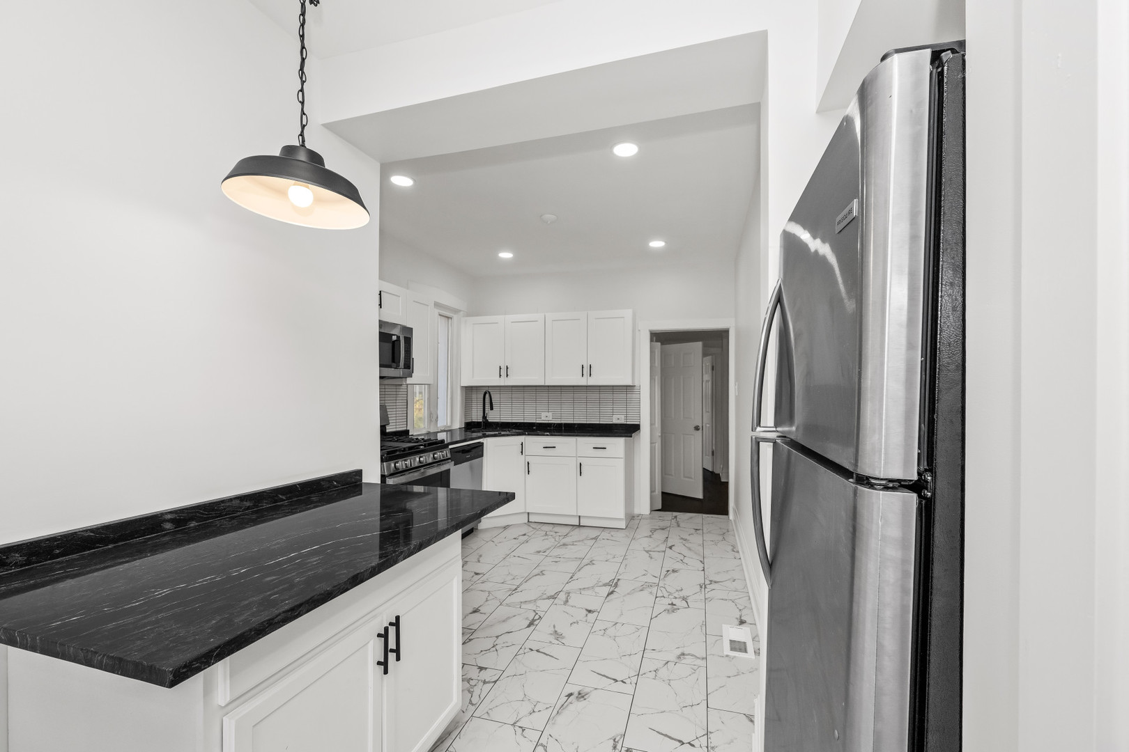 7832 South Paxton Avenue Chicago, IL 60649 - Photo 15 of 59 a kitchen with a refrigerator a oven and a sink