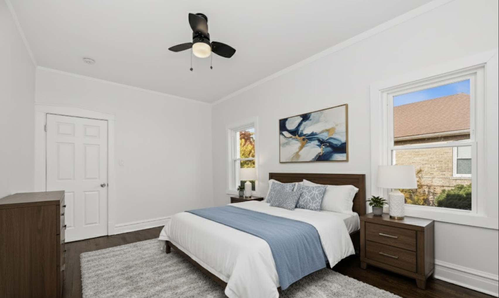 7832 South Paxton Avenue Chicago, IL 60649 - Photo 19 of 59 a bedroom with a large bed and a window