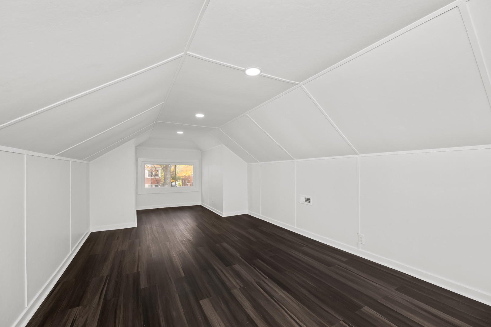 7832 South Paxton Avenue Chicago, IL 60649 - Photo 26 of 59 a view of an empty room with wooden floor and a window