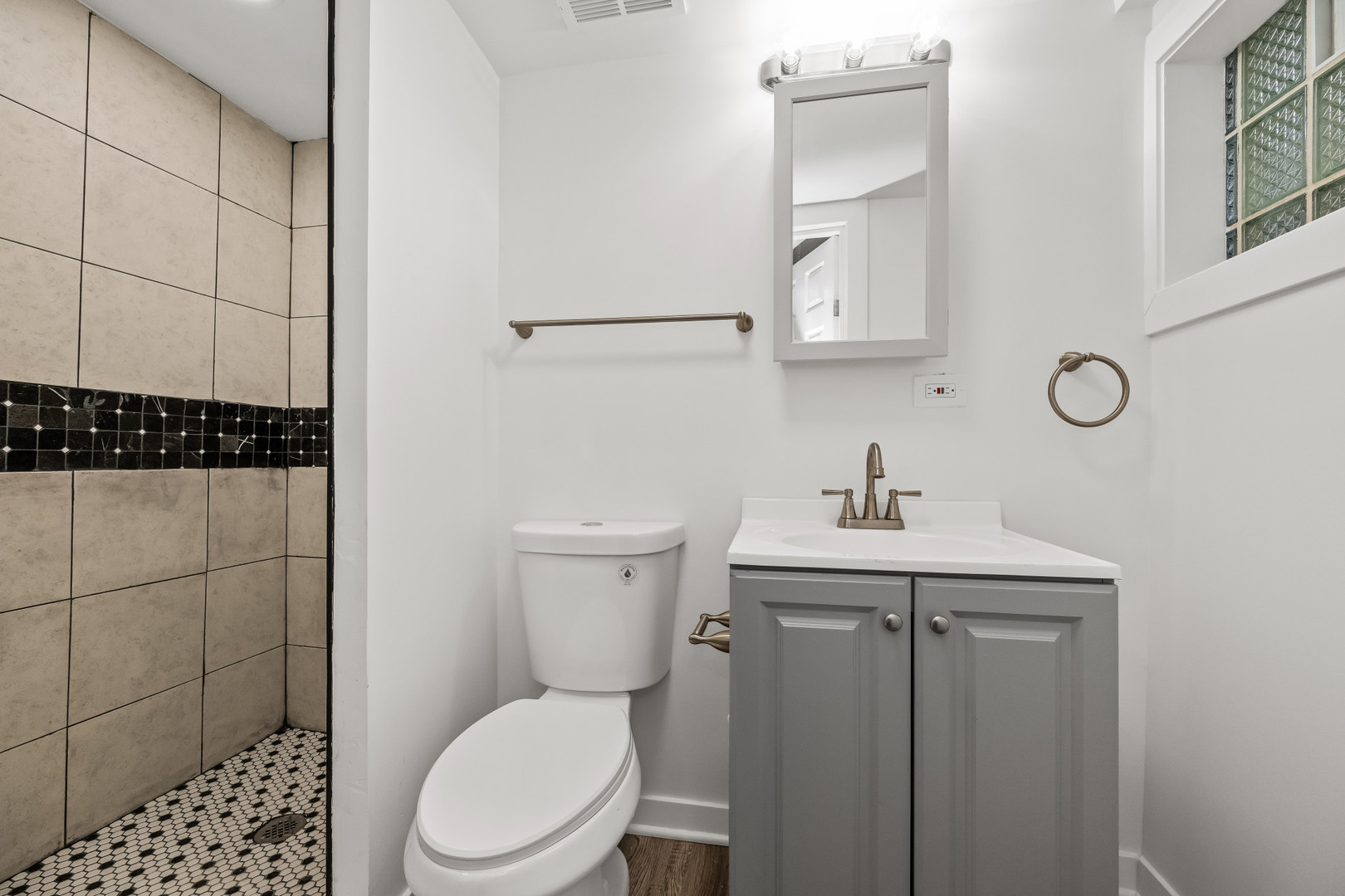 7832 South Paxton Avenue Chicago, IL 60649 - Photo 31 of 59 a bathroom with a toilet a sink and mirror