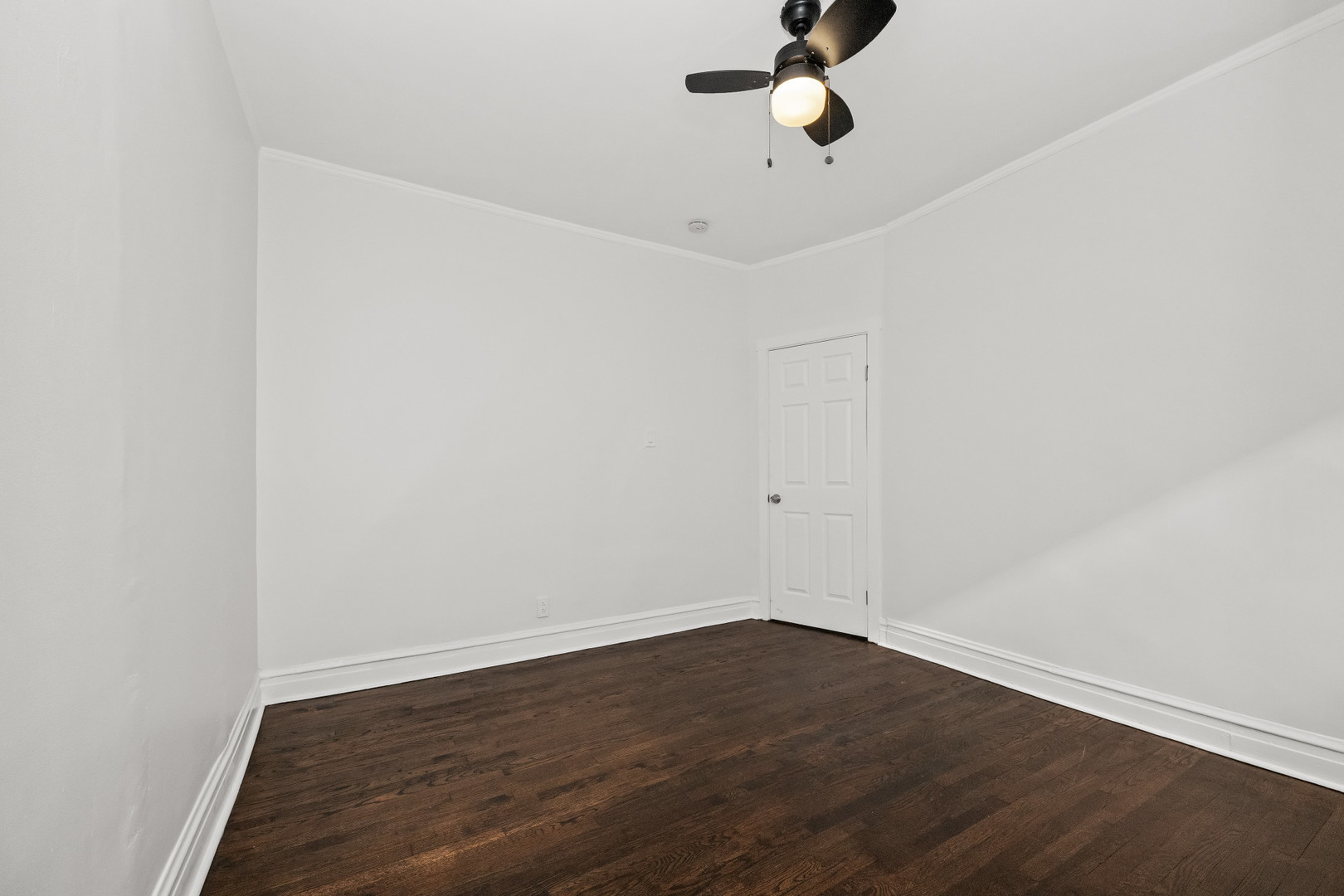 7832 South Paxton Avenue Chicago, IL 60649 - Photo 42 of 59 a view of a room with wooden floor and fan
