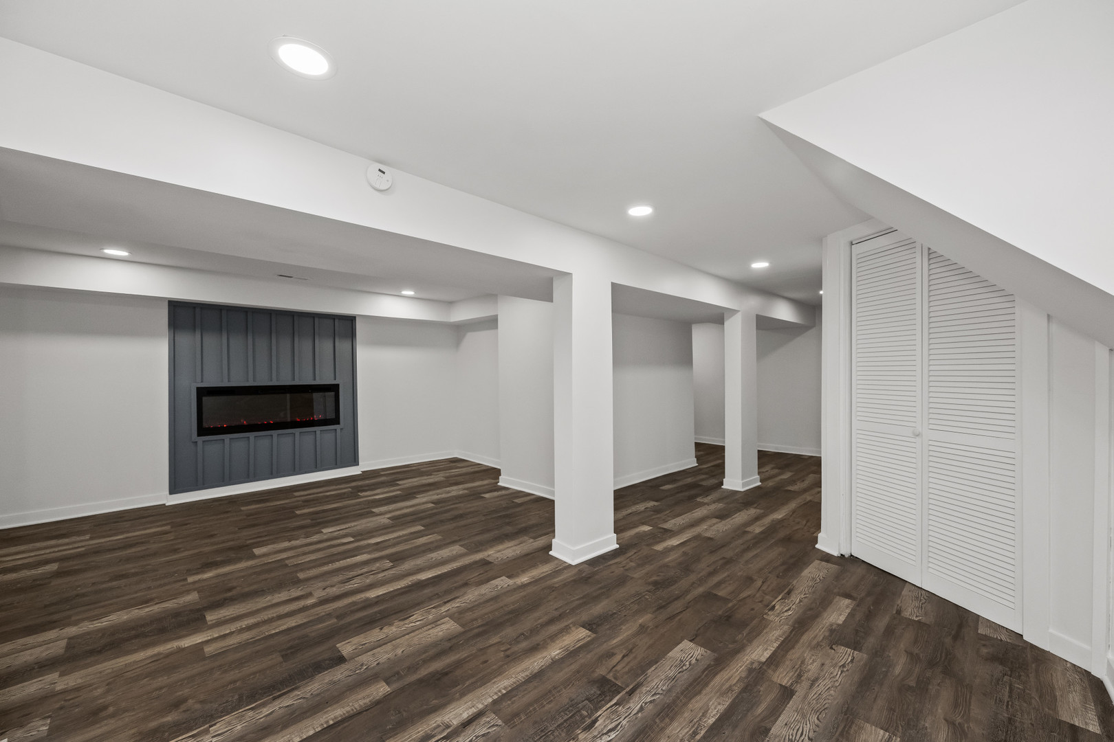 7832 South Paxton Avenue Chicago, IL 60649 - Photo 46 of 59 a view of an empty room with wooden floor and kitchen