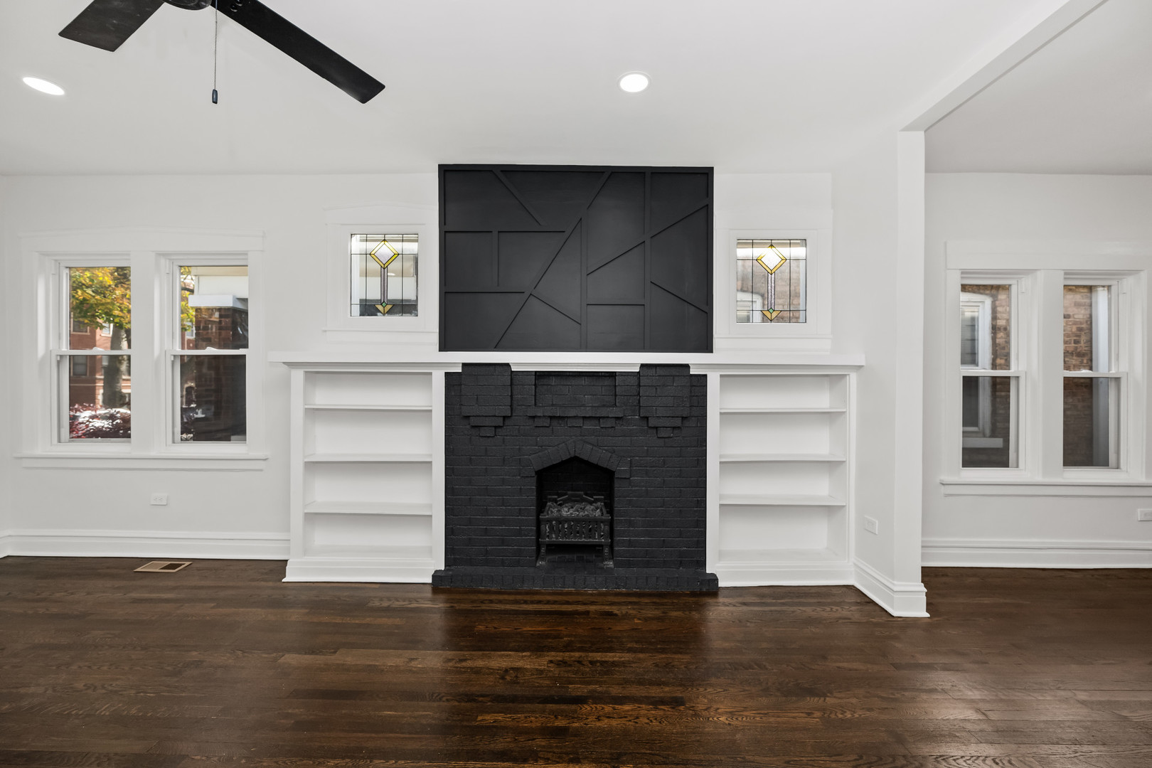 7832 South Paxton Avenue Chicago, IL 60649 - Photo 10 of 59 a living room with a fireplace and a floor to ceiling window