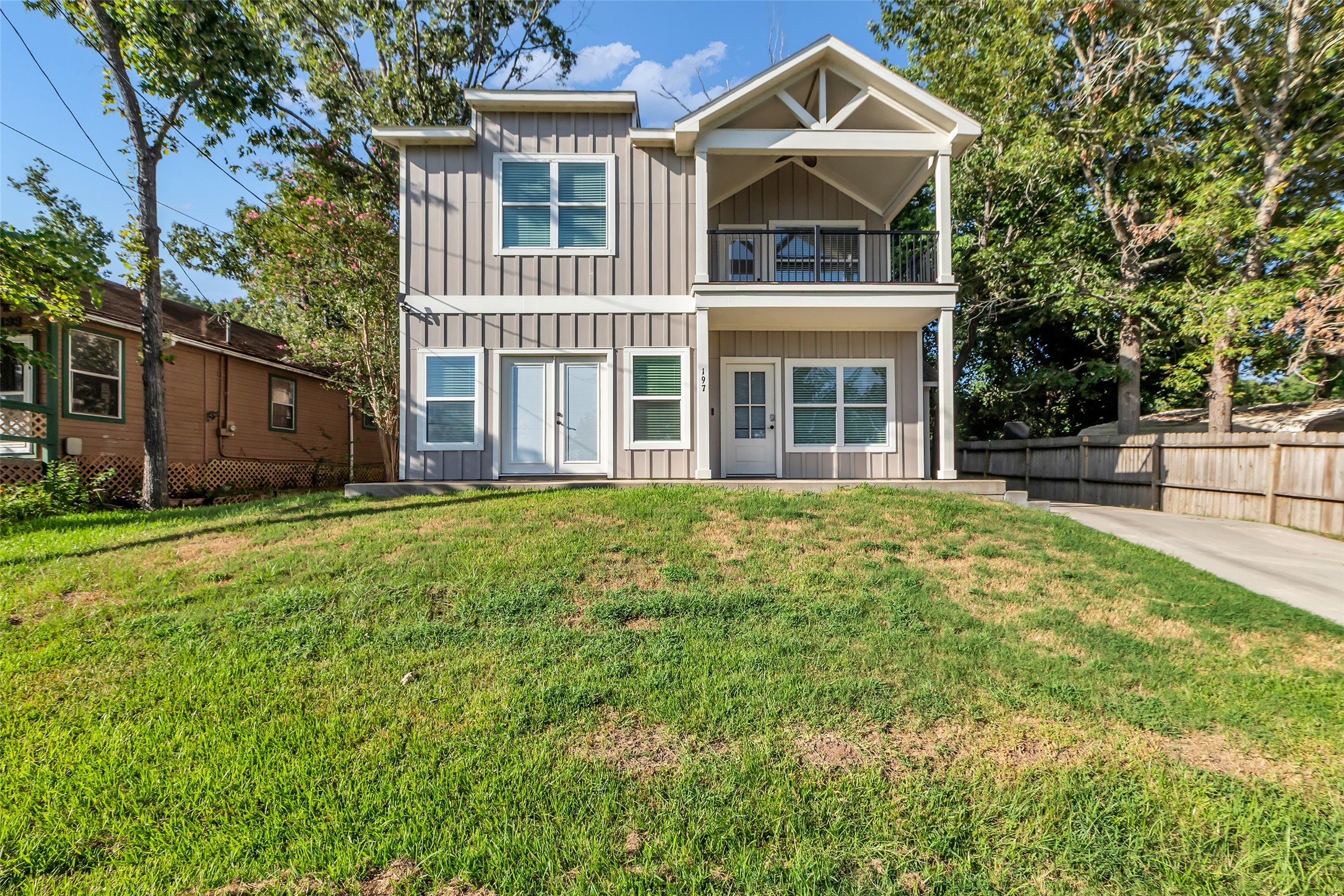 a front view of a house with a garden