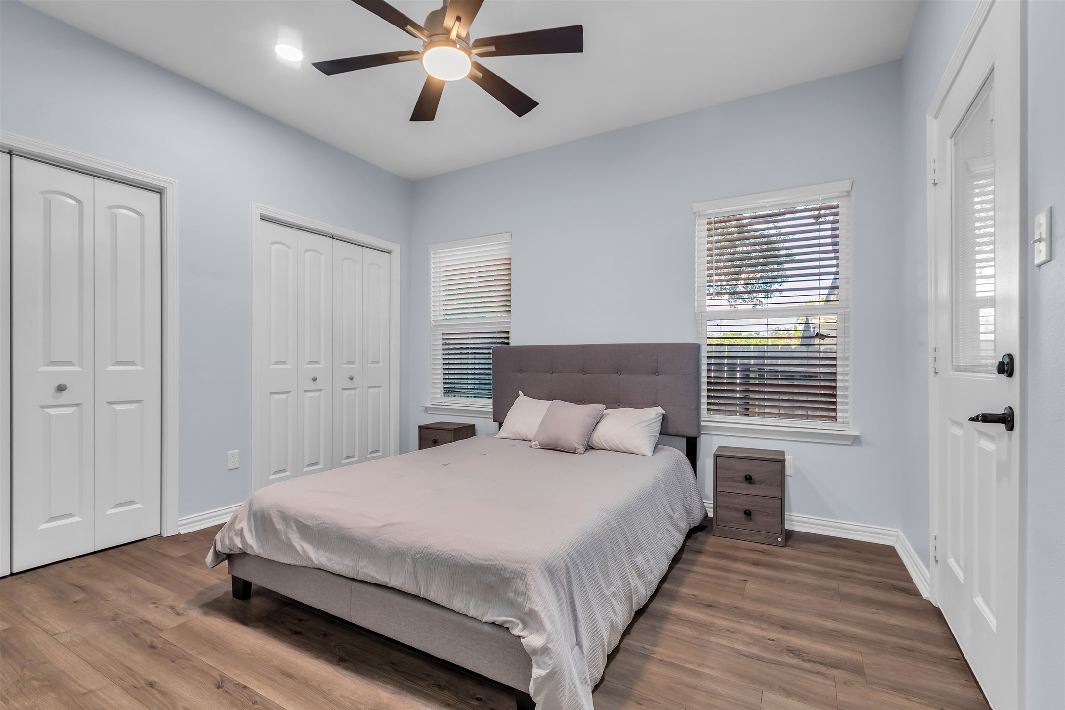 197 Rain Forest Road Onalaska, TX 77360 - Photo 15 of 25 a bedroom with a large bed chandelier and a window
