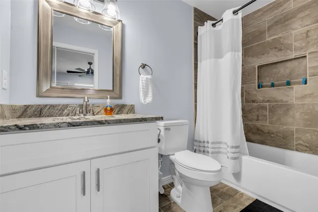 a bathroom with a toilet a sink and bathtub