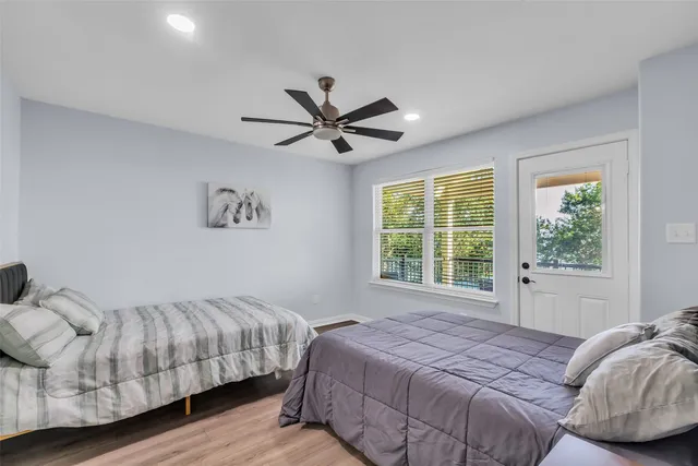 a bedroom with a bed and a large window