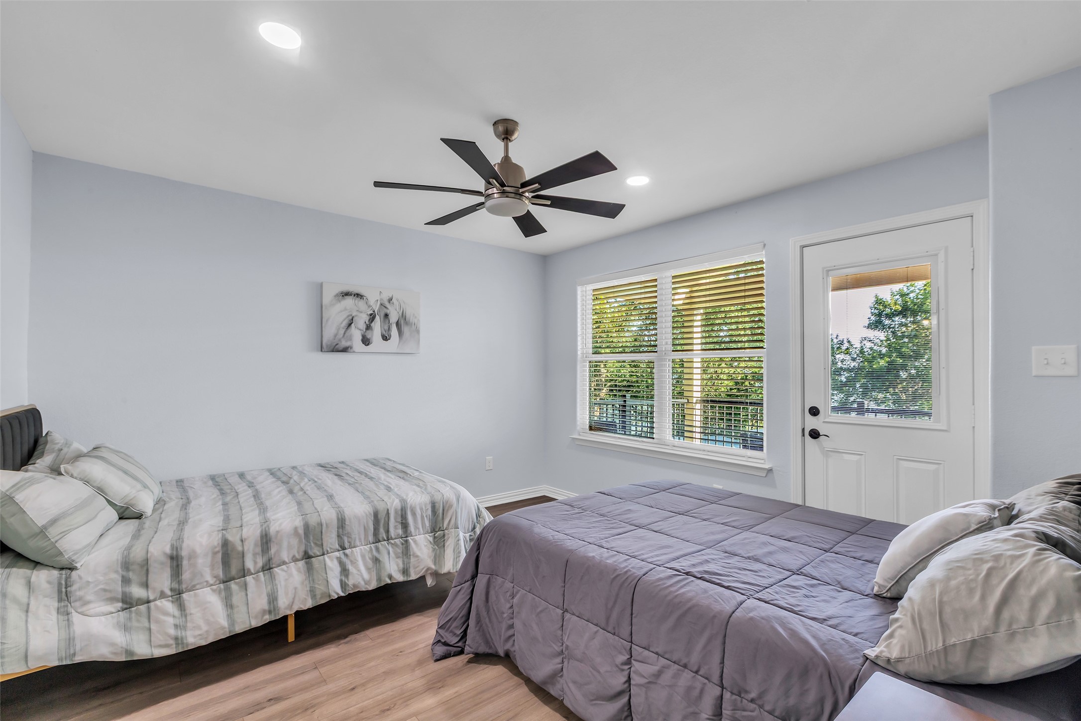 197 Rain Forest Road Onalaska, TX 77360 - Photo 18 of 25 a bedroom with a bed and a large window