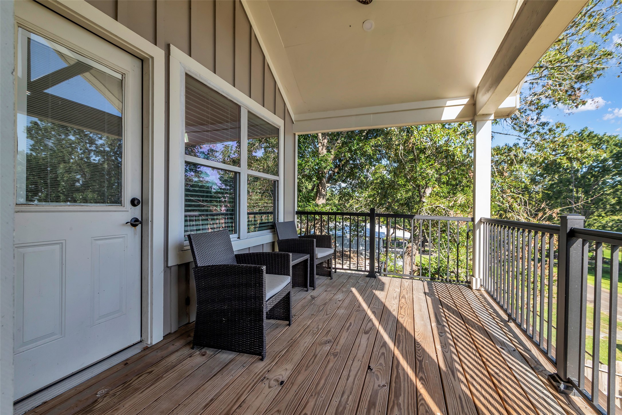 197 Rain Forest Road Onalaska, TX 77360 - Photo 21 of 25 a view of a balcony with chairs and wooden floor