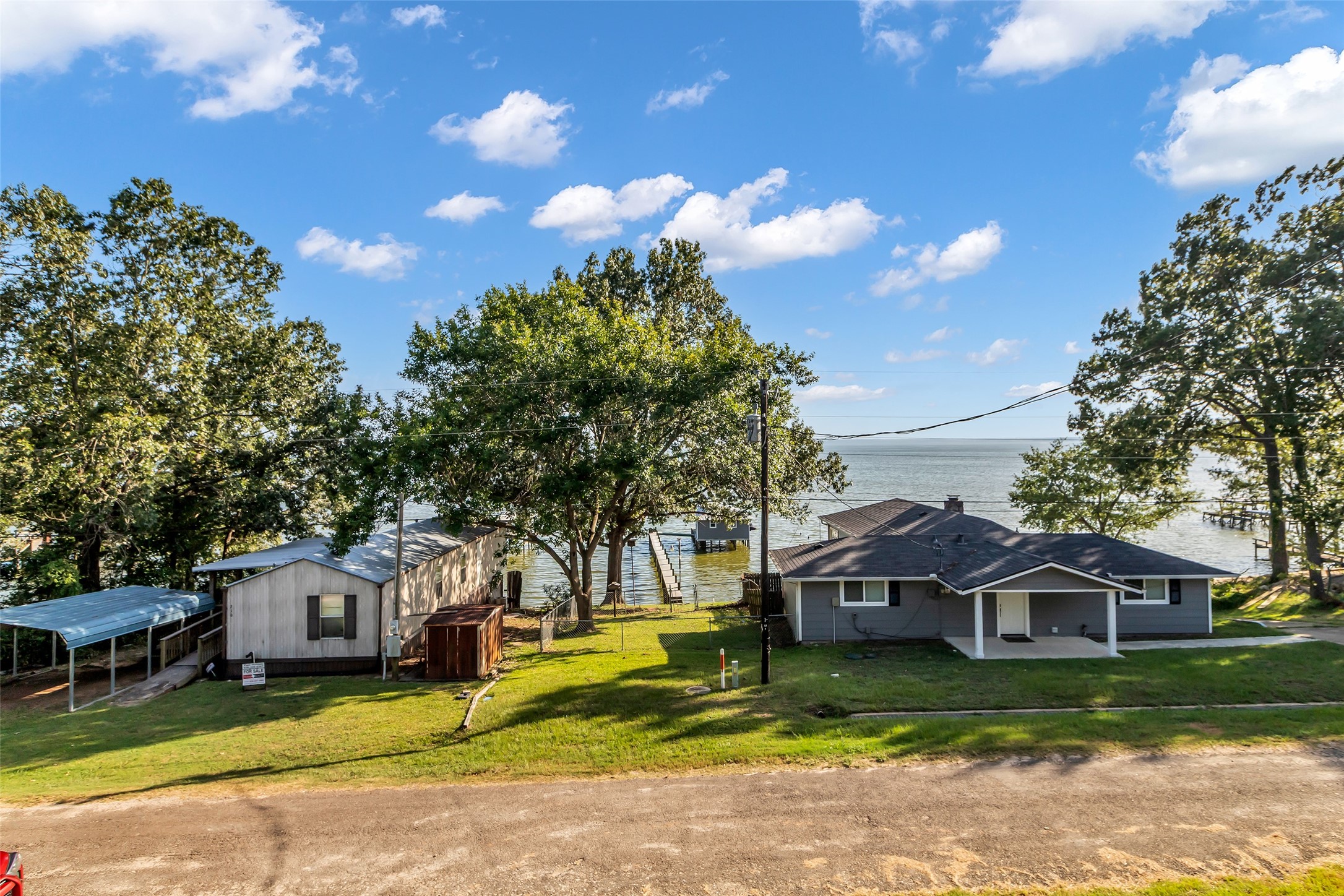 197 Rain Forest Road Onalaska, TX 77360 - Photo 23 of 25 a front view of a house with a garden and trees