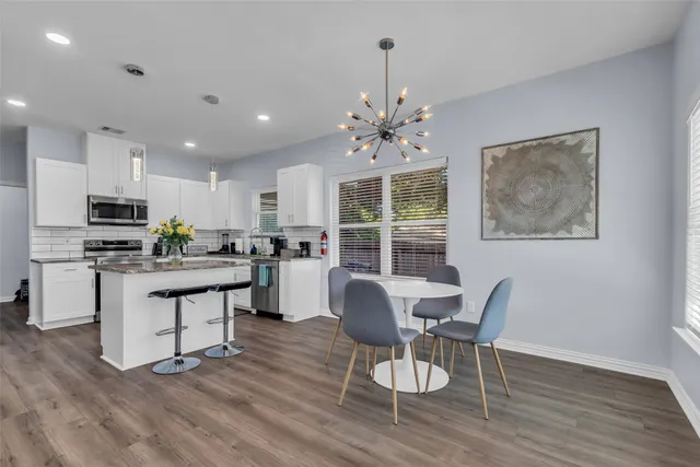 a view of kitchen with dining table and chairs