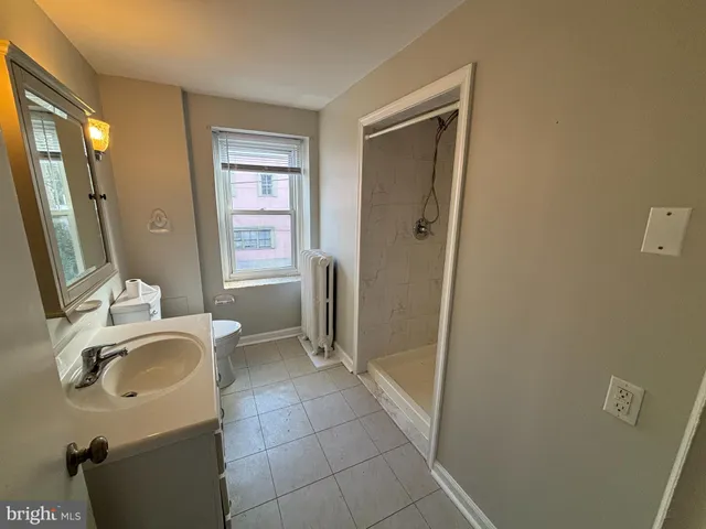 a bathroom with a sink a toilet and a mirror