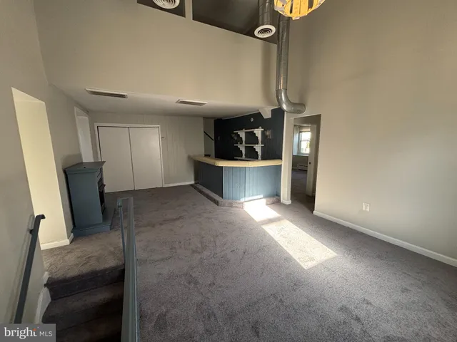 a view of a kitchen with a sink cabinets and a ceiling fan