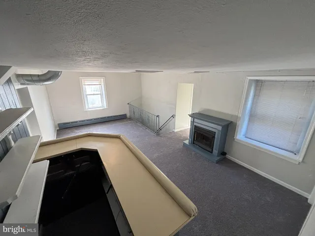a view of living room with a fireplace and furniture