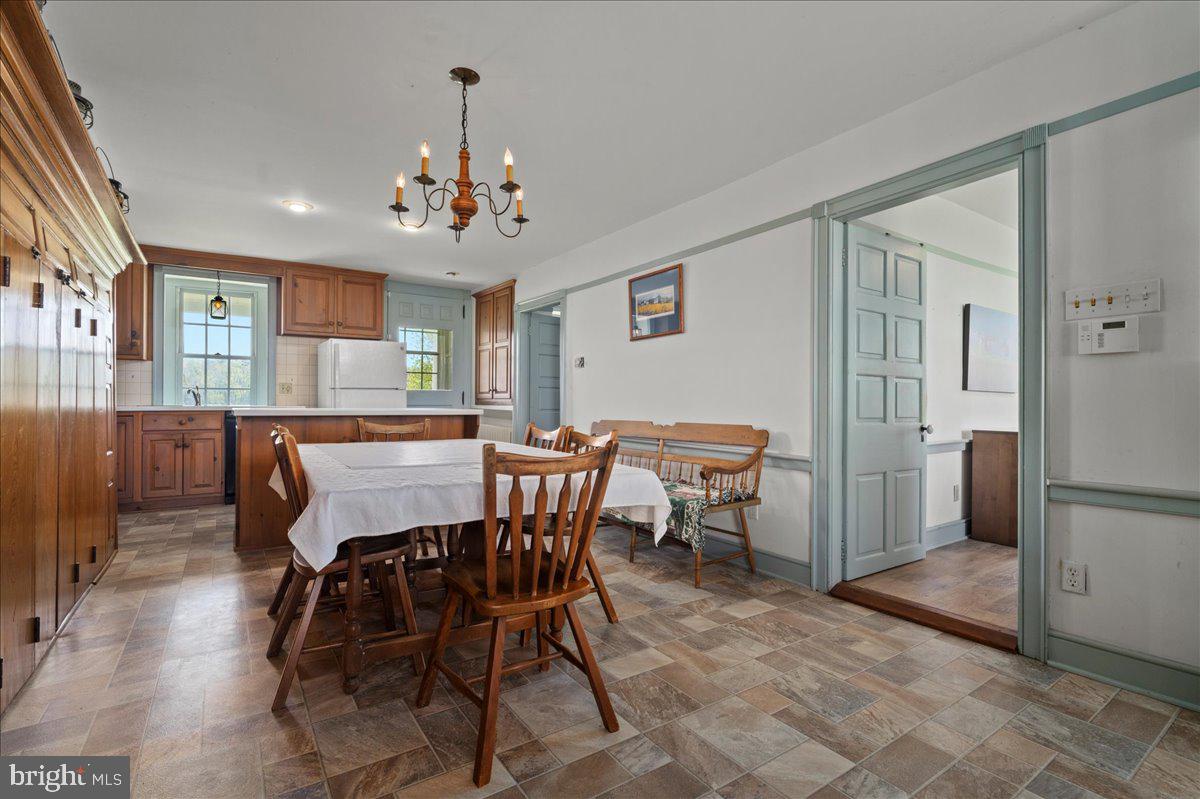 215 Nockamixon Road Kintnersville, PA 18930 - Photo 15 of 55 a view of a dining room with furniture and chandelier