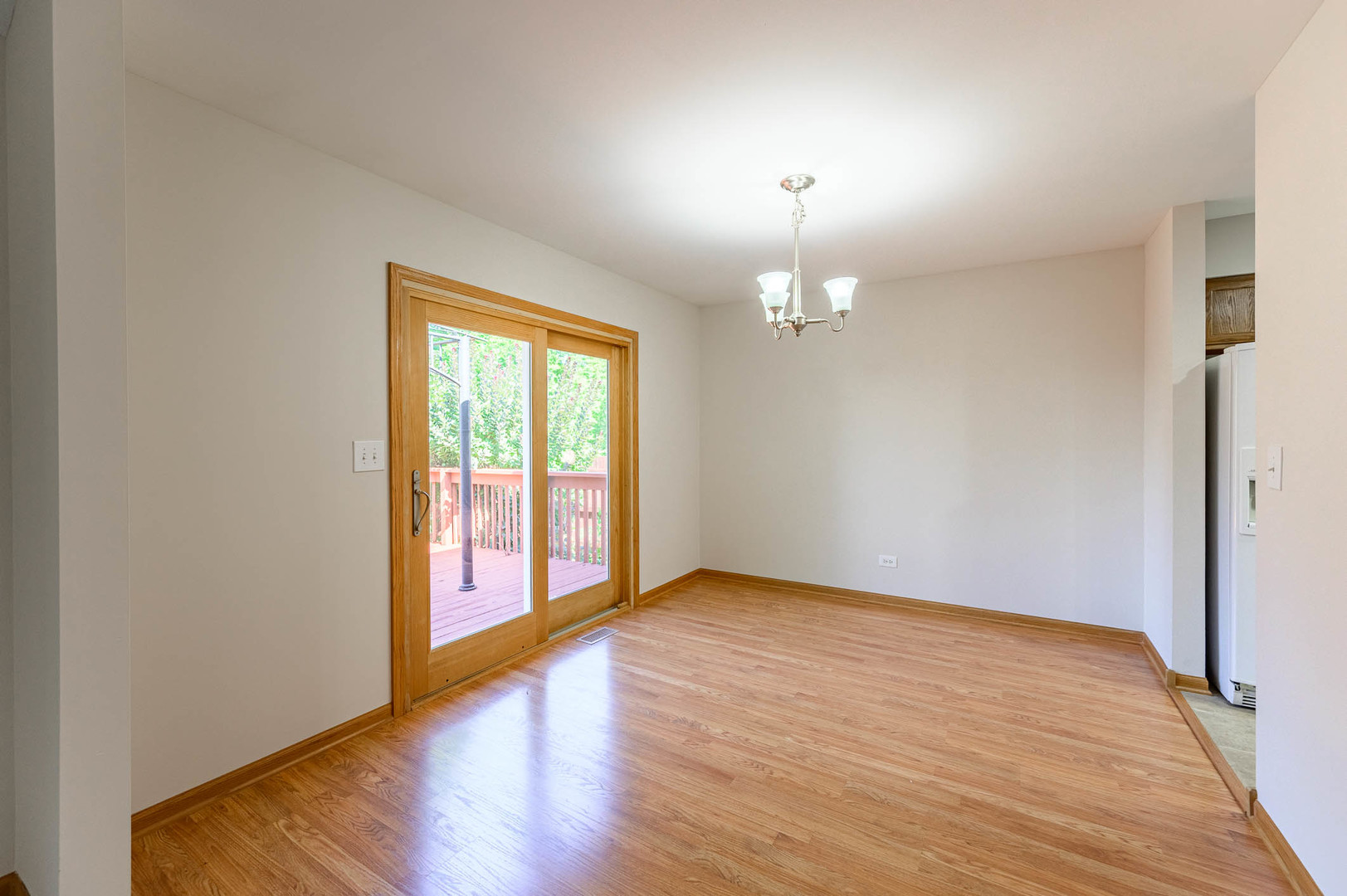 638 Colony Avenue Lindenhurst, IL 60046 - Photo 3 of 15 a view of an empty room with wooden floor and a window