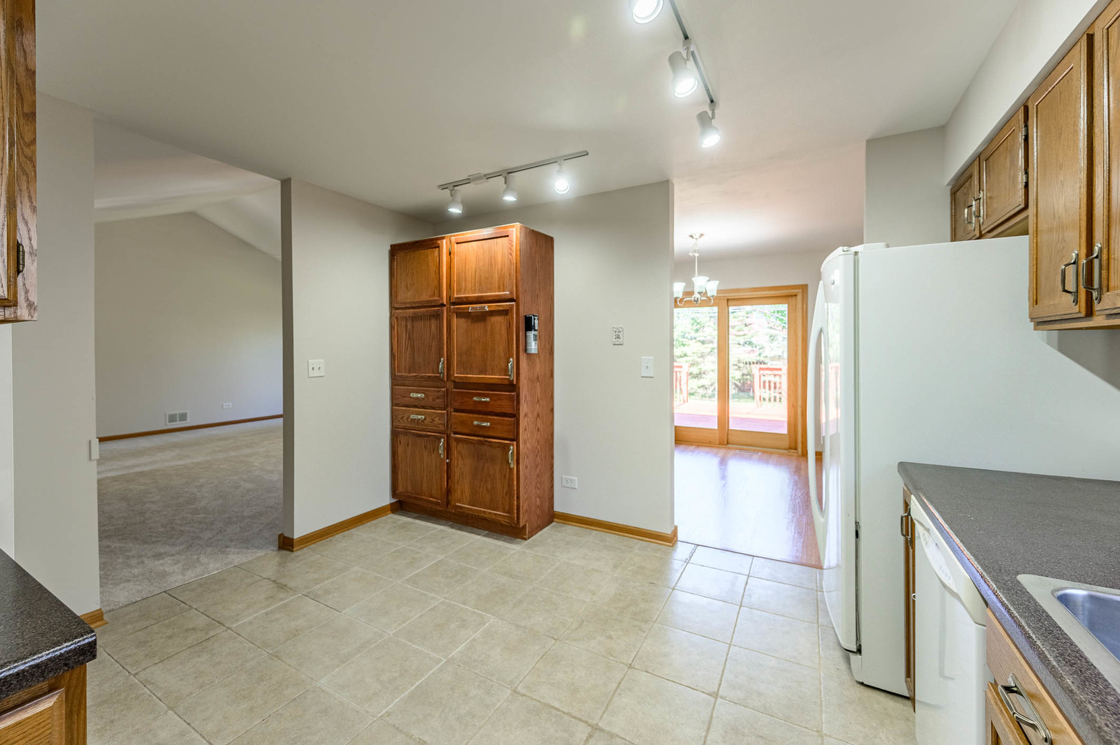 638 Colony Avenue Lindenhurst, IL 60046 - Photo 5 of 15 a view of a kitchen with a sink and a refrigerator