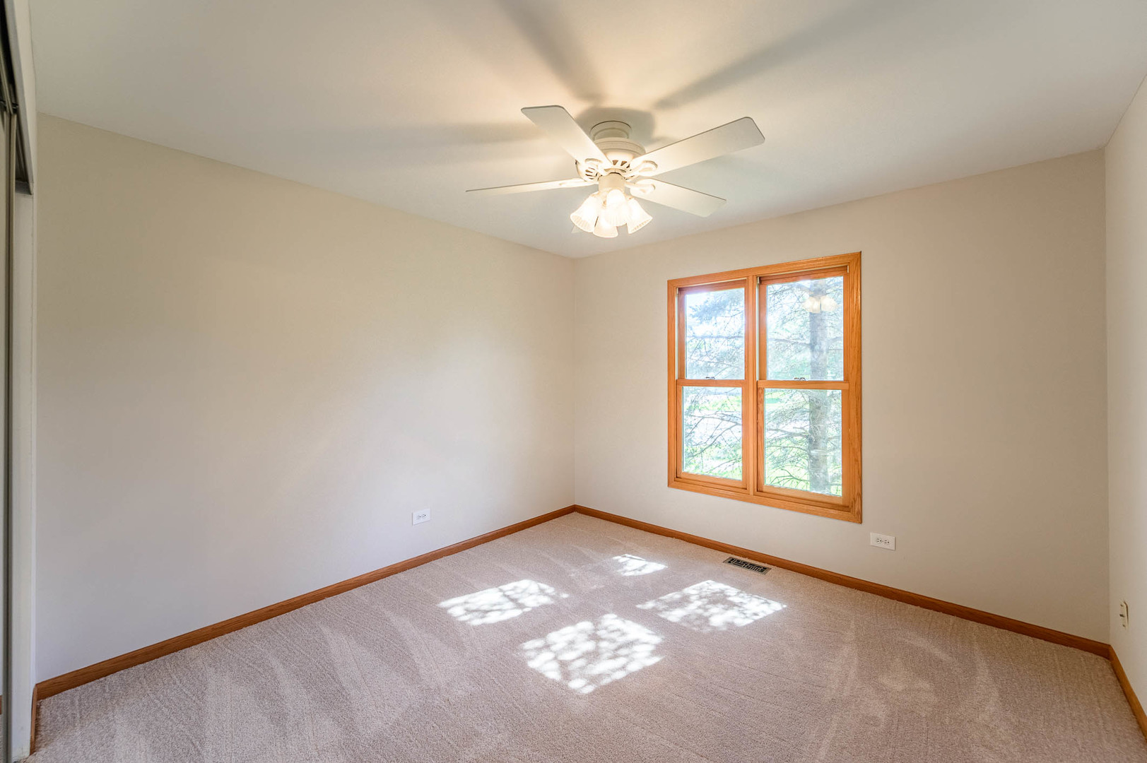 638 Colony Avenue Lindenhurst, IL 60046 - Photo 6 of 15 an empty room with windows and fan